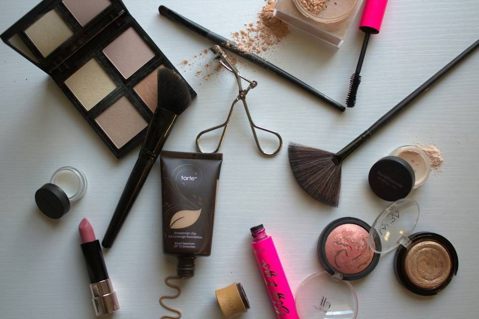 Beauty blogger writing makeup reviews at a vanity
